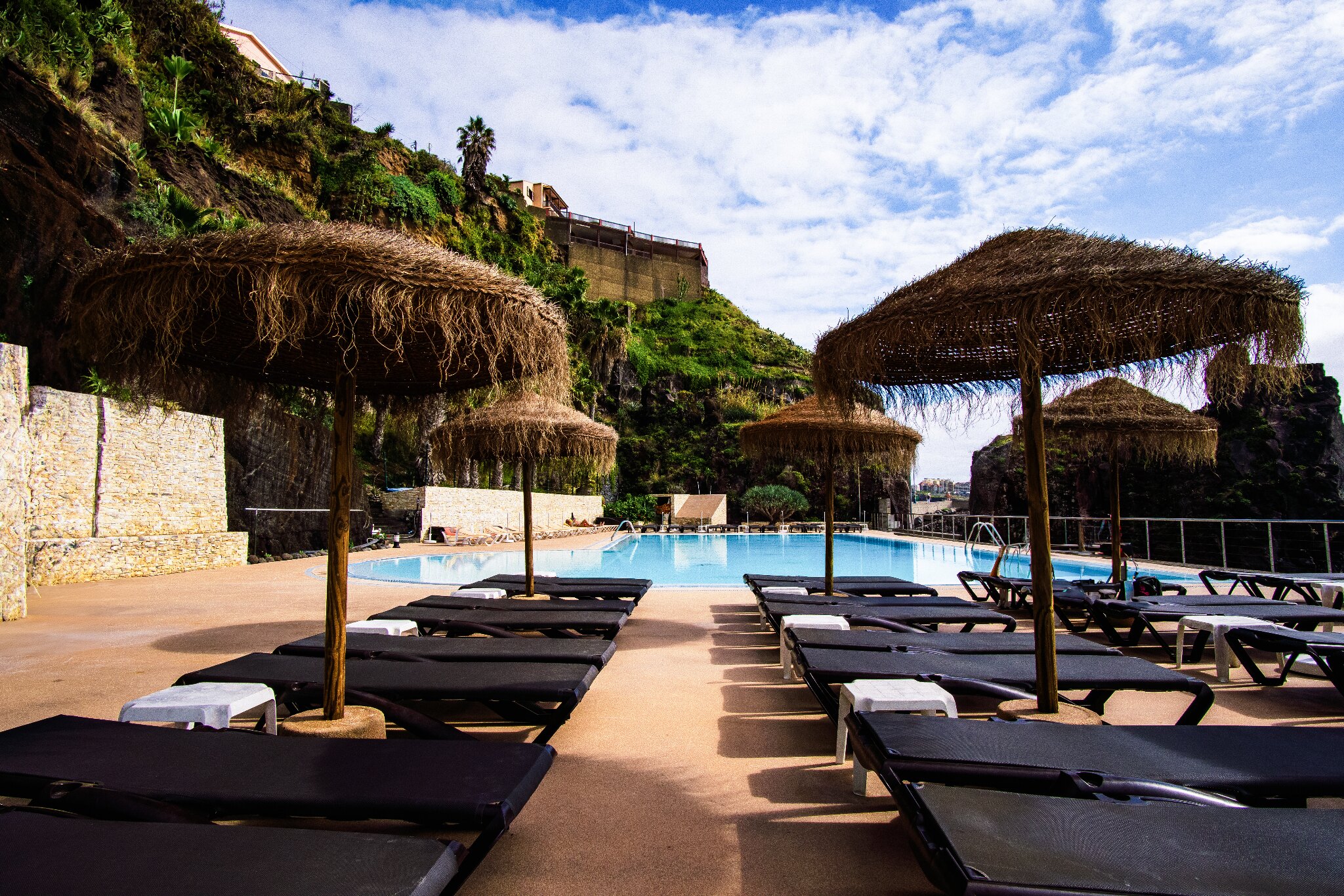 Pool terrace beneath the volcanic cliffs